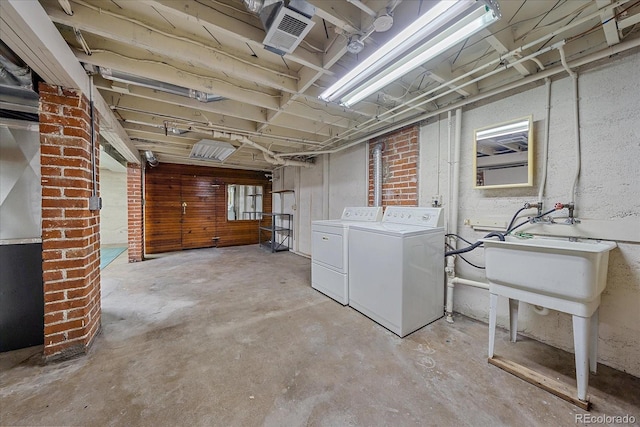 basement with separate washer and dryer and sink