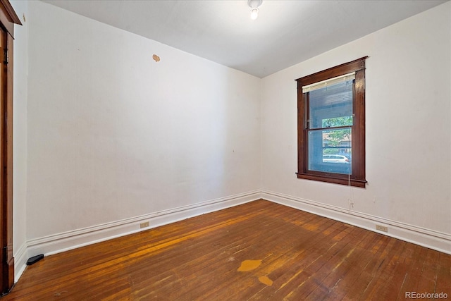 unfurnished room with hardwood / wood-style flooring