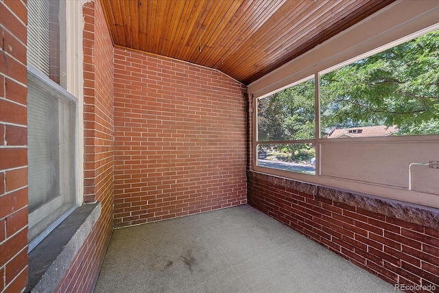 unfurnished sunroom with vaulted ceiling and wooden ceiling