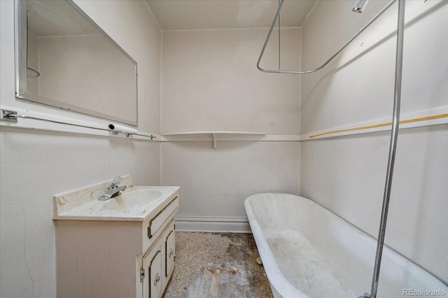 bathroom featuring a washtub and vanity