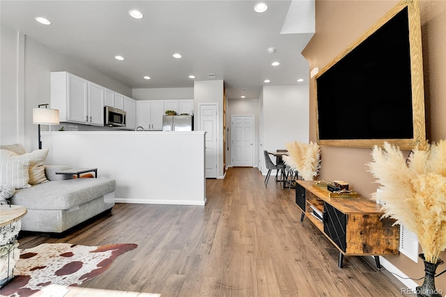 6459 N Dunkirk St, Denver, CO 80249 - living area featuring light wood-style floors and recessed lighting
