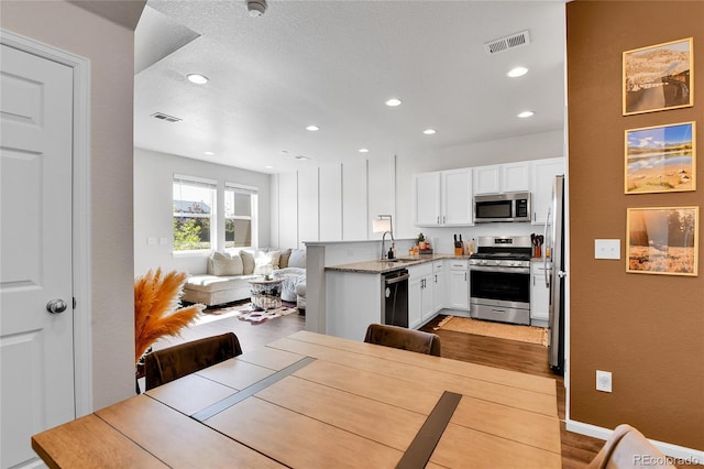 6459 N Dunkirk St, Denver, CO 80249 - dining area with recessed lighting and light wood-style flooring