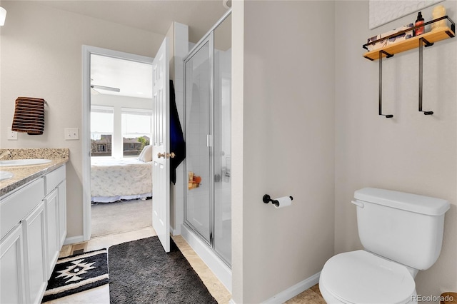 6459 N Dunkirk St, Denver, CO 80249 - ensuite bathroom with a stall shower, toilet, vanity, and baseboards