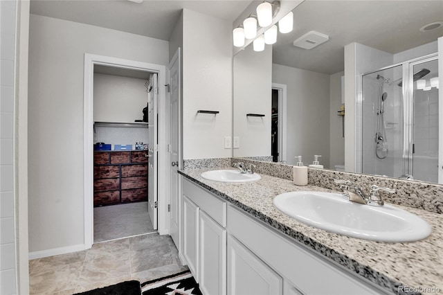 6459 N Dunkirk St, Denver, CO 80249 - bathroom featuring a shower stall, double vanity, and a spacious closet