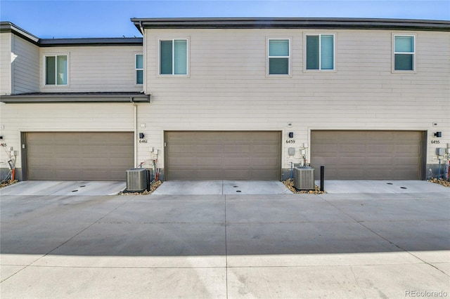 6459 N Dunkirk St, Denver, CO 80249 - view of front facade with an attached garage, cooling unit, and driveway