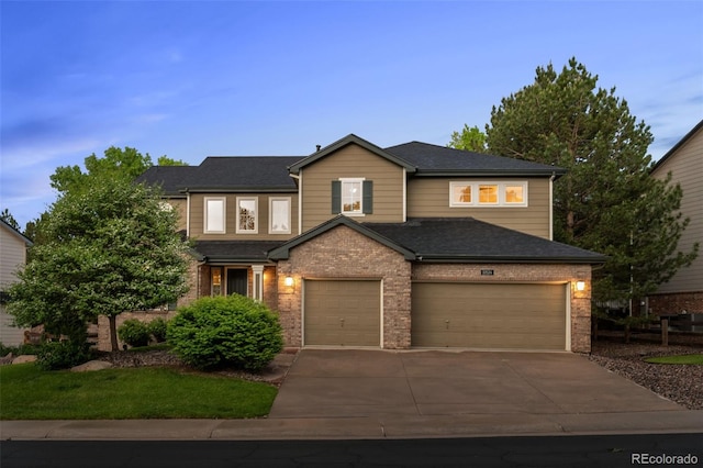 10524 Serengeti Dr, Lone Tree, CO 80124 - view of front facade with driveway, brick siding, and an attached garage