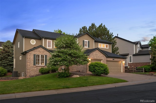 10524 Serengeti Dr, Lone Tree, CO 80124 - view of front of home featuring brick siding, concrete driveway, central AC, a front lawn, and a garage