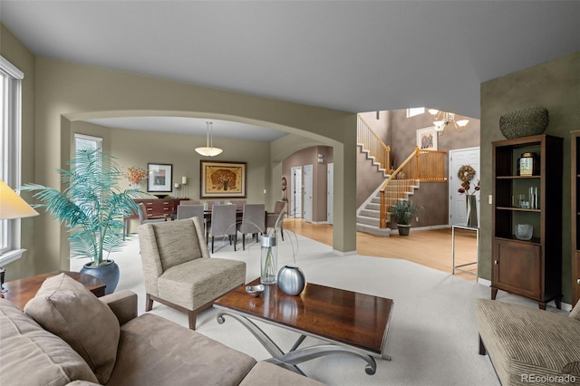 10524 Serengeti Dr, Lone Tree, CO 80124 - living area with arched walkways, stairway, wood finished floors, and a chandelier