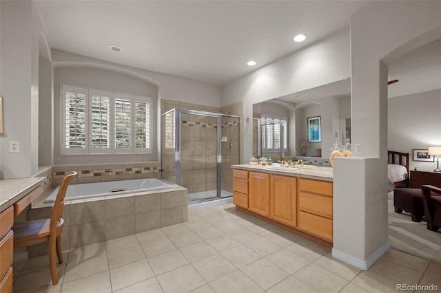 10524 Serengeti Dr, Lone Tree, CO 80124 - full bathroom featuring vanity, tile patterned floors, a bath, a shower stall, and recessed lighting