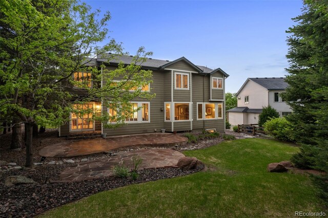 10524 Serengeti Dr, Lone Tree, CO 80124 - rear view of property with a lawn and a patio