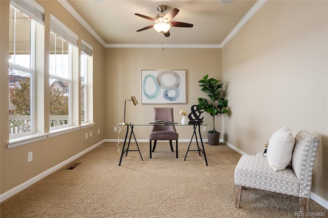 home office with carpet floors, a healthy amount of sunlight, visible vents, and ornamental molding