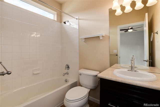 full bath with  shower combination, vanity, toilet, and a ceiling fan