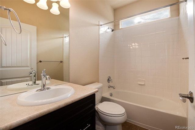 bathroom featuring toilet, vanity, and bathing tub / shower combination