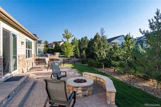 view of patio / terrace with a residential view and a fire pit