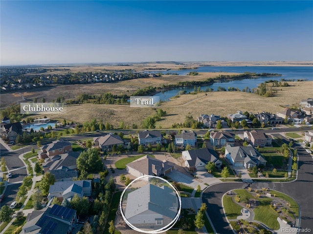 drone / aerial view with a water view and a residential view