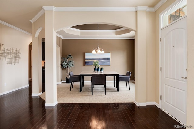 dining room featuring baseboards, arched walkways, dark wood finished floors, and a notable chandelier