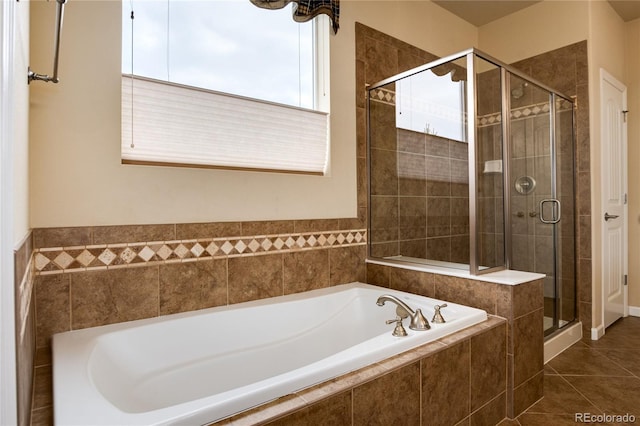 full bathroom with a garden tub, a stall shower, and tile patterned floors