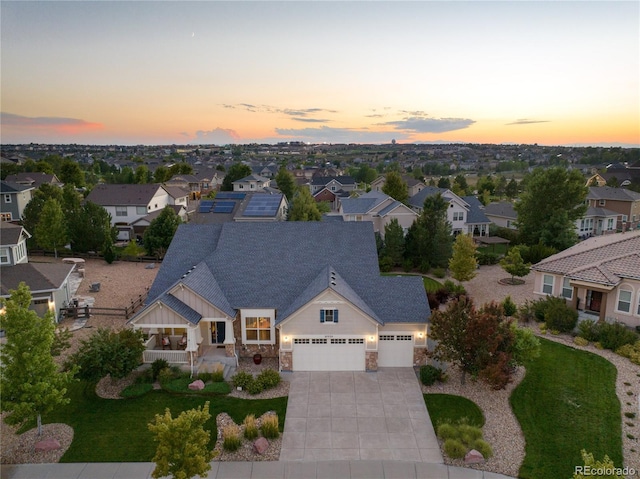 aerial view at dusk featuring a residential view