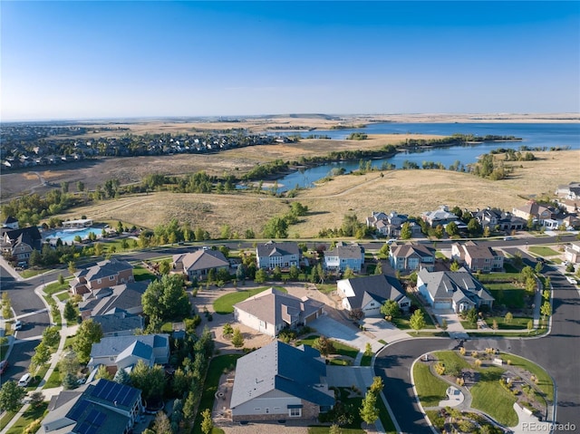 drone / aerial view with a water view and a residential view