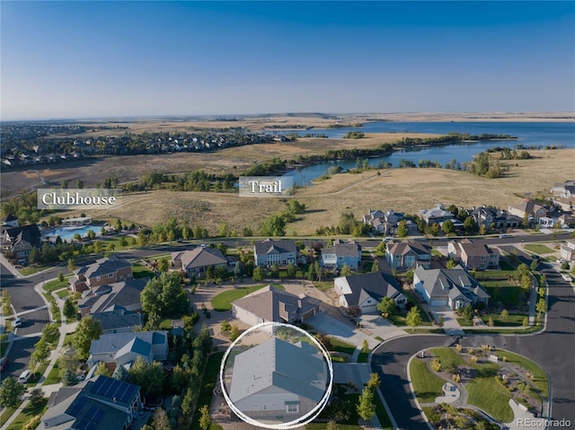 birds eye view of property featuring a water view and a residential view
