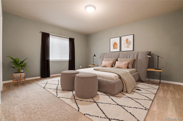 bedroom with baseboards and carpet