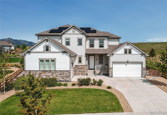 9571 Yucca Ct, Arvada, CO 80007 - view of front of house featuring stone siding, driveway, solar panels, a porch, and a garage