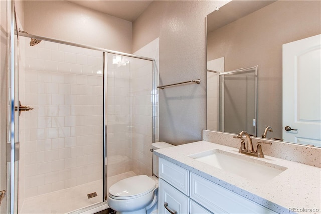 9571 Yucca Ct, Arvada, CO 80007 - bathroom featuring toilet, vanity, and a stall shower