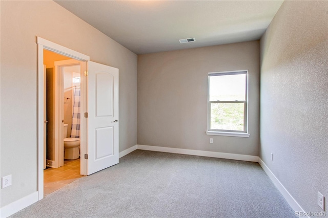 9571 Yucca Ct, Arvada, CO 80007 - unfurnished bedroom with light colored carpet, baseboards, and light tile patterned floors