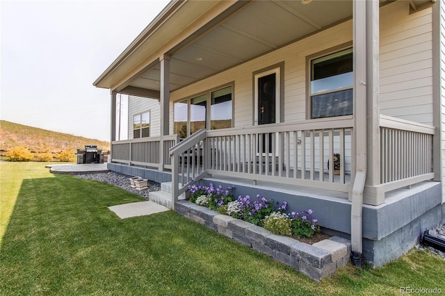 9571 Yucca Ct, Arvada, CO 80007 - entrance to property featuring covered porch and a yard