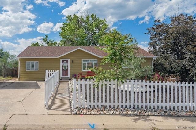 1817 S Perry Way, Denver, CO 80219 - view of front facade featuring a fenced front yard and roof with shingles