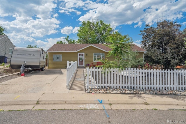 1817 S Perry Way, Denver, CO 80219 - view of front of property featuring a fenced front yard, concrete driveway, and a shingled roof