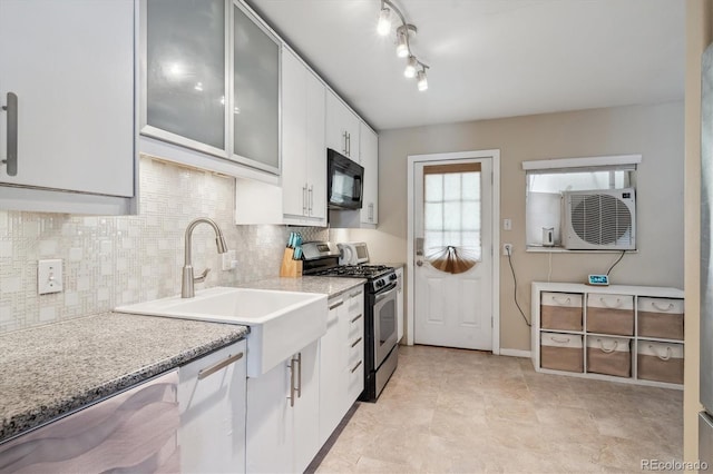 1817 S Perry Way, Denver, CO 80219 - kitchen with stainless steel gas stove, black microwave, glass insert cabinets, white cabinetry, and backsplash