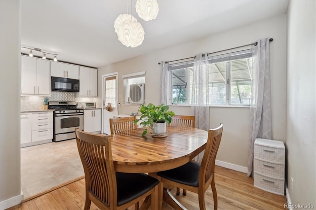 1817 S Perry Way, Denver, CO 80219 - dining room featuring light wood-style floors and baseboards