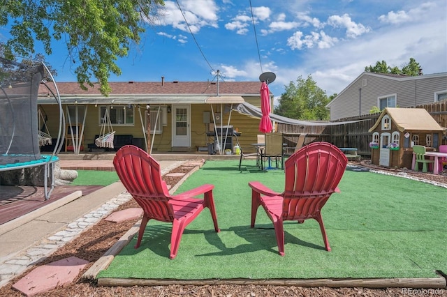 1817 S Perry Way, Denver, CO 80219 - back of property featuring a trampoline and a patio