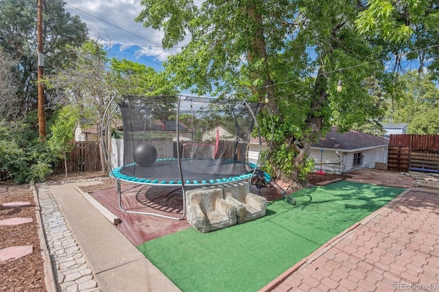 1817 S Perry Way, Denver, CO 80219 - fenced backyard featuring a trampoline