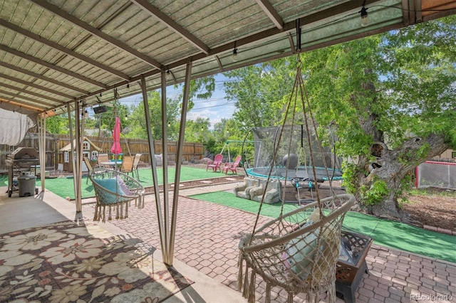 1817 S Perry Way, Denver, CO 80219 - fenced backyard featuring a trampoline, a patio area, a playground, and grilling area