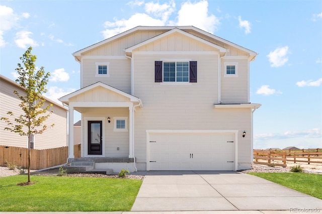 view of front of house with a front lawn, driveway, fence, board and batten siding, and a garage