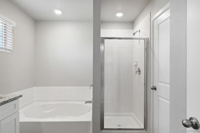 bathroom with vanity and separate shower and tub