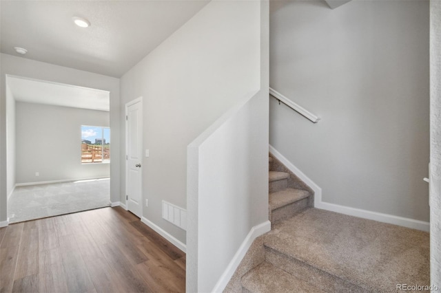 stairway featuring dark wood-type flooring