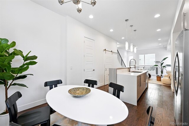 2830 W 32nd Ave, Denver, CO 80211 - dining area featuring a barn door, dark wood finished floors, and recessed lighting
