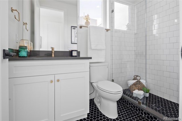 2012 W 46th Ave, Denver, CO 80211 - bathroom featuring toilet, vanity, tile patterned flooring, and tiled shower