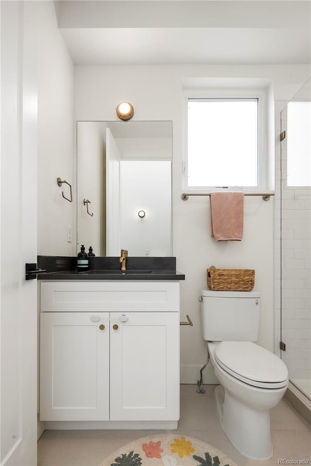 2012 W 46th Ave, Denver, CO 80211 - bathroom featuring toilet, vanity, a shower stall, and tile patterned floors