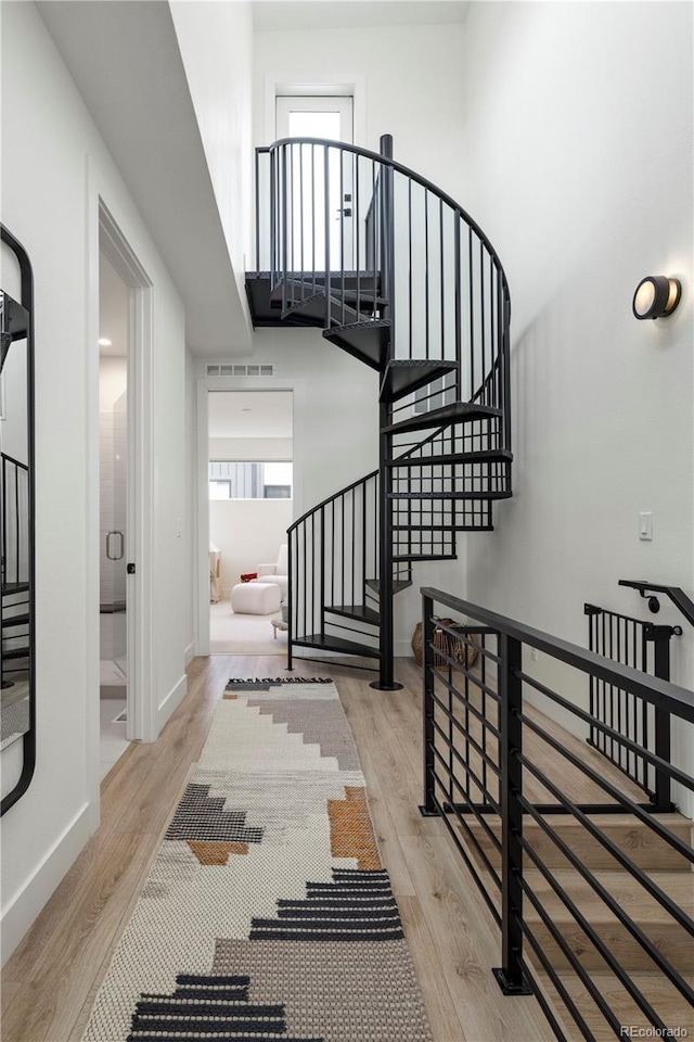 2012 W 46th Ave, Denver, CO 80211 - stairway featuring wood finished floors, baseboards, and a towering ceiling