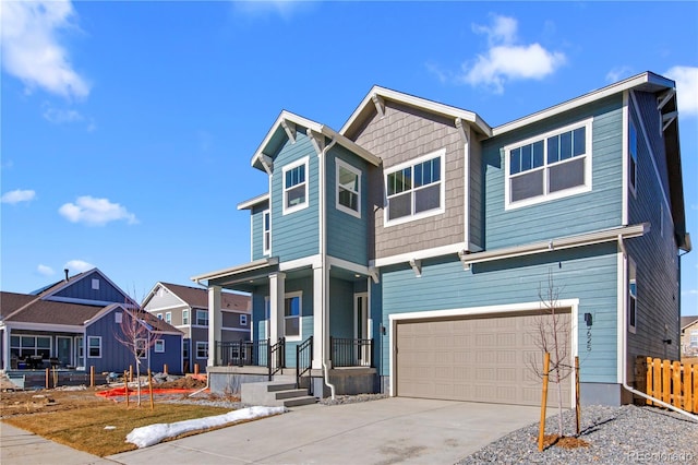 view of front of property featuring covered porch, concrete driveway, fence, a garage, and a residential view