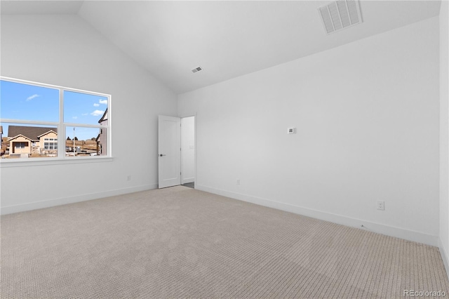 carpeted spare room featuring high vaulted ceiling, baseboards, and visible vents