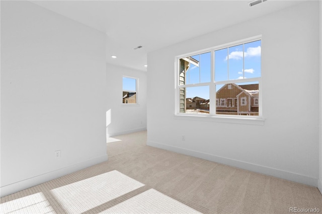 unfurnished room featuring carpet, visible vents, baseboards, and recessed lighting