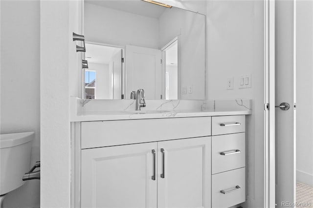 bathroom with toilet and vanity