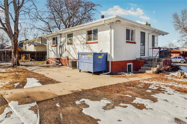 rear view of house featuring central air condition unit