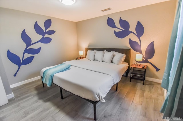 bedroom featuring wood-type flooring