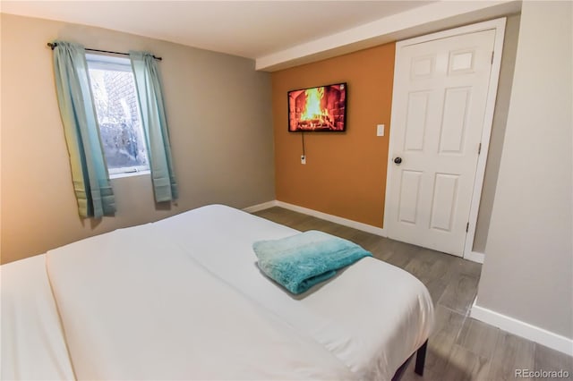 bedroom with hardwood / wood-style floors